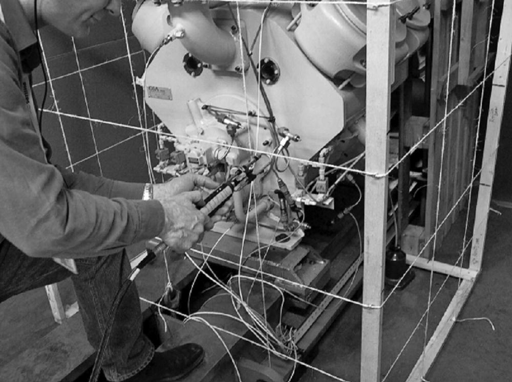 Photo depicts indoor sound power measurement of a reciprocating compressor.