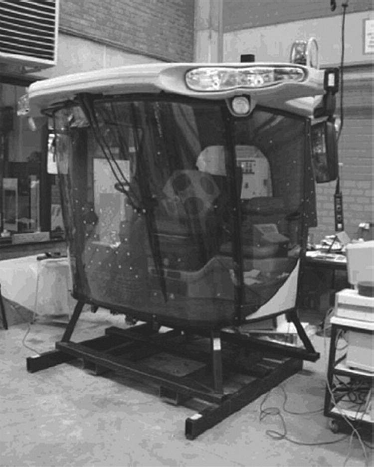 Photo depicts operator cabin of an agricultural harvester machine.