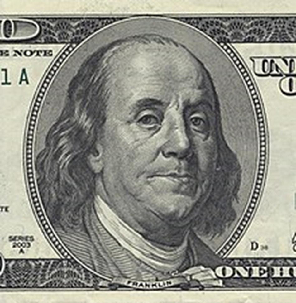 Portrait of President Benjamin Franklin on 100 US dollar bill.